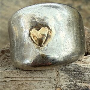 Sterling silver wide tapered band with a 14k gold heart. One of a kind.